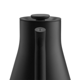 Matte black electric kettle with a tapered body, long slim handle, and flat lid knob.