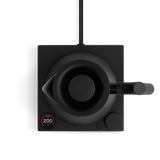 Matte black electric kettle with minimalist round body, ergonomic handle, and digital temperature display on square base.