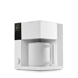 Compact white precision coffee maker with a black control panel and matching white ceramic carafe.