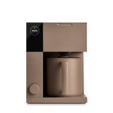 Matte brown compact coffee maker with cylindrical carafe and simple knob control.