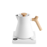 White electric kettle with a conical stainless steel body, wooden handle and knob, placed on a white digital base with.