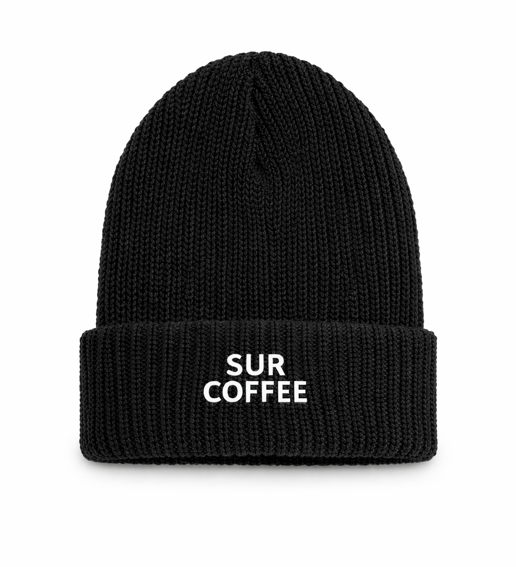 Black ribbed knit beanie with folded cuff and white Sur Coffee logo embroidered on front.