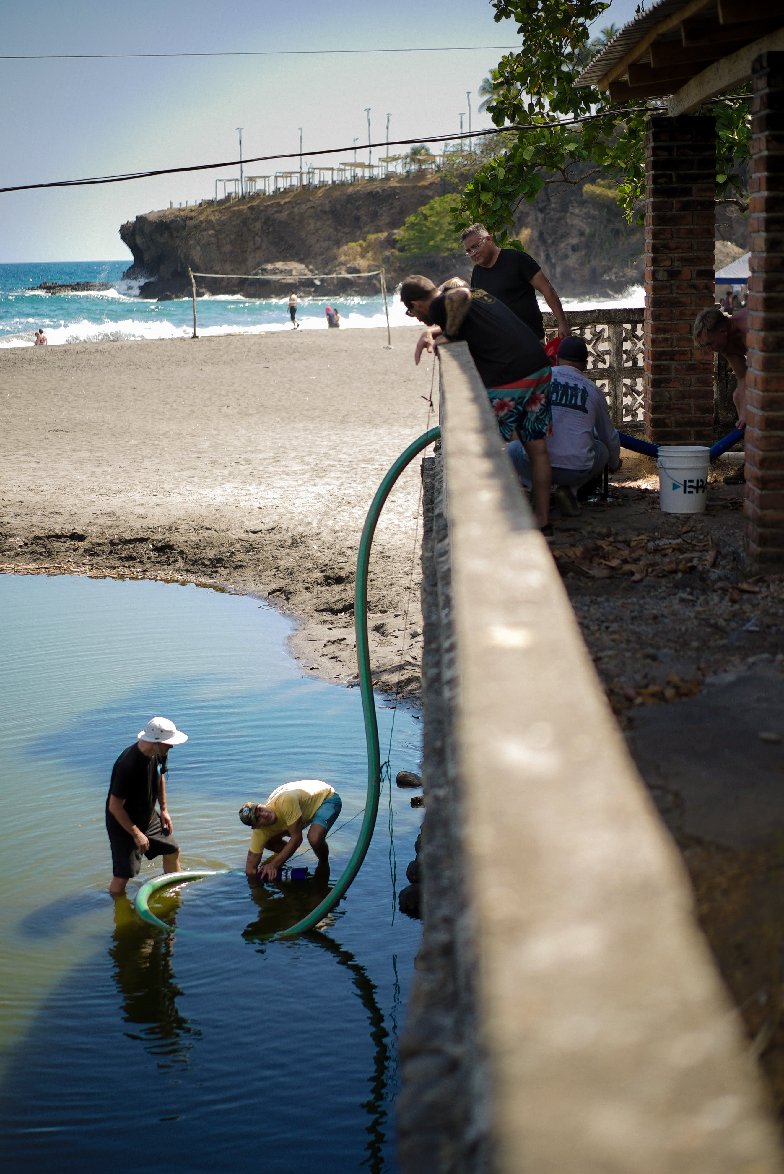 Men filtering clean water from ocean water