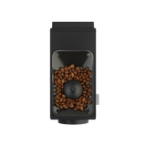 Matte black rectangular coffee grinder with transparent bean hopper filled with brown coffee beans and a silver side button.