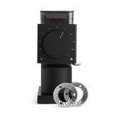 Matte black electric coffee grinder with large numbered dial and two silver grinding burrs displayed in front.