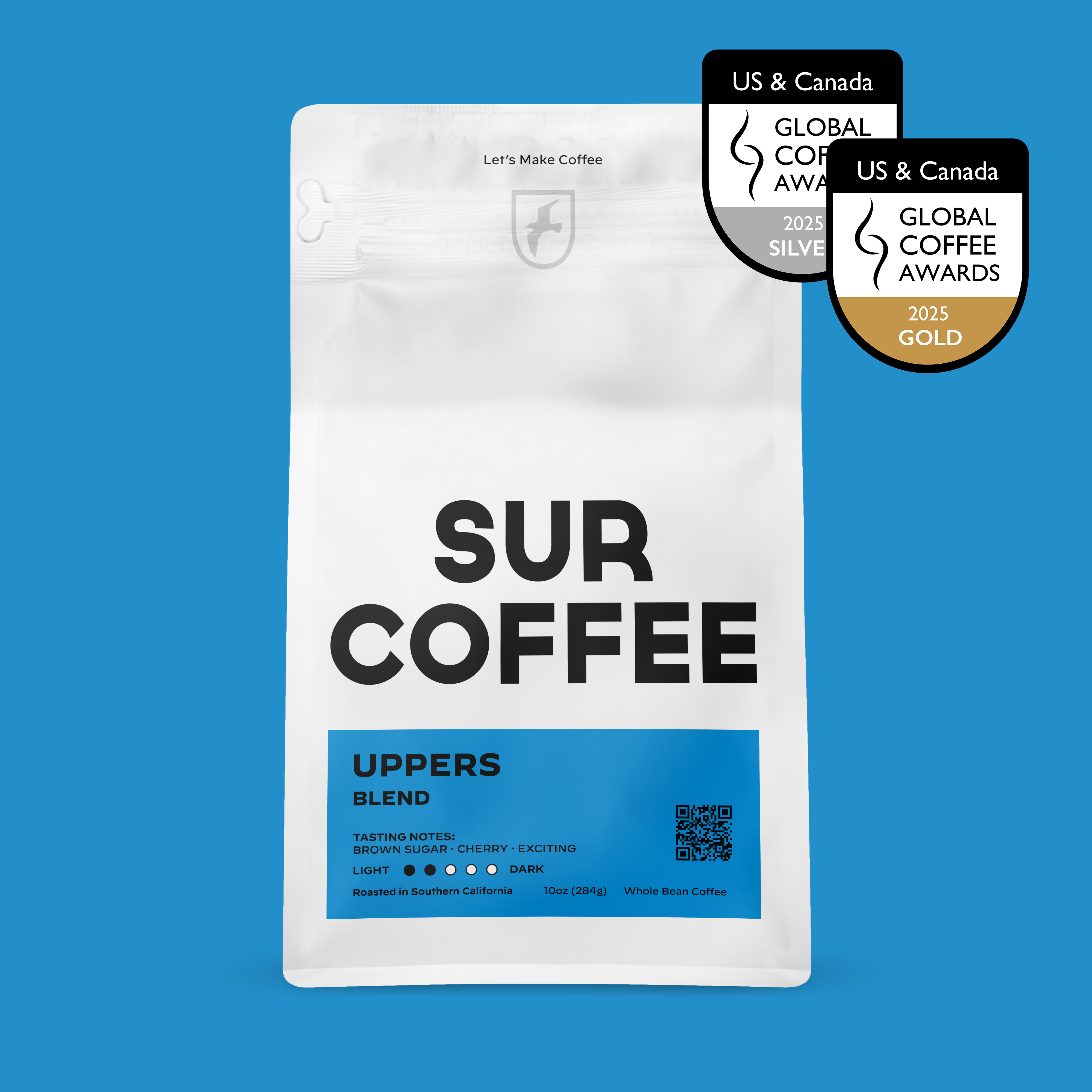 White resealable bag of SUR COFFEE Uppers Blend with blue label and award badges on blue background.
