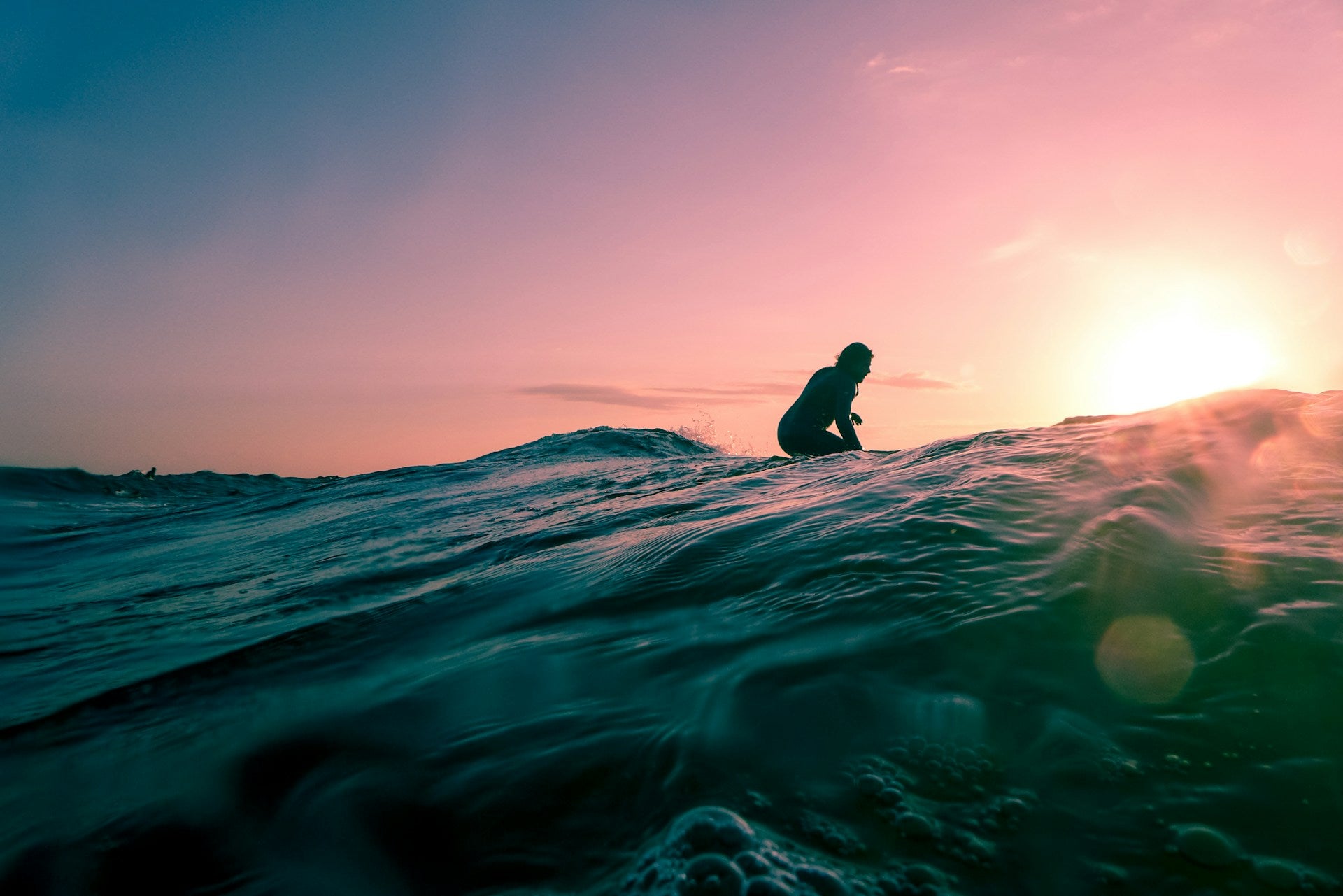 hero image of a man surfing