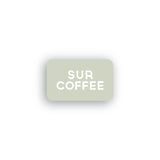 Light gray rectangular Sur Coffee gift card with bold white text centered on a white background.